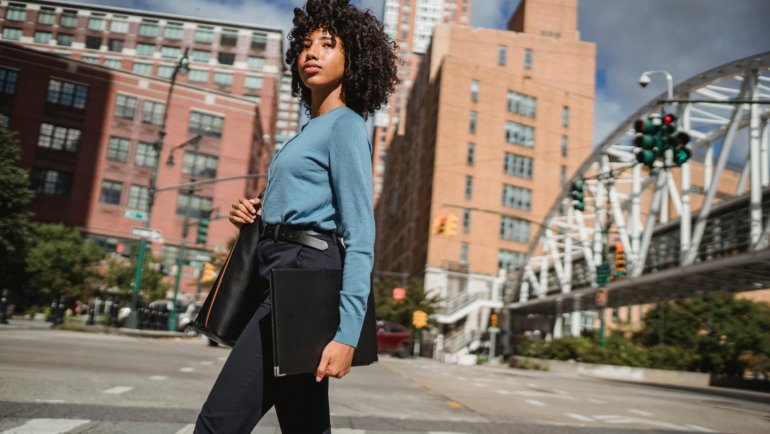 A professional certified surgical technologist (CST) confidently looking at a dynamic city skyline, symbolizing the career growth, high earning potential, and travel adventure offered by surgical tech travel jobs.