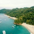 Lush Costa Rican landscape featuring vibrant rainforest meeting a pristine tropical beach, ideal for diverse travel experiences and planning the best time to visit.