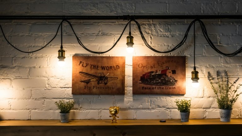 Stylish living room featuring a curated gallery wall of framed vintage travel posters, enhancing modern home decor with a touch of nostalgic adventure and artistic flair.