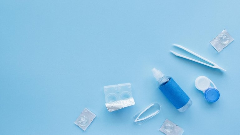 Clear Care travel size contact lens solution bottle in a clear TSA-approved carry-on bag, demonstrating effortless packing for contact lens wearers.