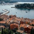 Panoramic view of a charming Croatian coastal town with the sparkling Adriatic Sea, representing the best time to plan your dream trip to Croatia and its diverse seasonal offerings.