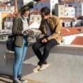 Happy person consulting a map or smartphone to discover local hidden gems, planning a day trip or weekend getaway for an accessible travel adventure near home.