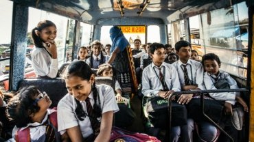 A diverse group of smiling middle and high school students participating in a cultural activity or adventure abroad, representing Putney Student Travel's immersive summer programs for global awareness and personal growth.
