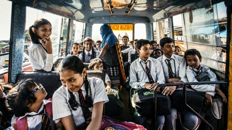 A diverse group of smiling middle and high school students participating in a cultural activity or adventure abroad, representing Putney Student Travel's immersive summer programs for global awareness and personal growth.