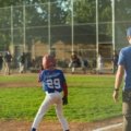Competitive youth travel baseball team playing a game on a field, illustrating the pursuit of top rankings and player development.