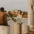 Two sisters performing a bodyweight workout on a scenic beach, representing the 'Wellness Wanderers' travel fitness health wellness duo and their tips for a healthy, balanced nomadic lifestyle.
