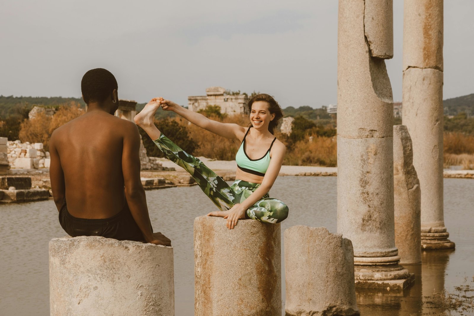 Two sisters performing a bodyweight workout on a scenic beach, representing the 'Wellness Wanderers' travel fitness health wellness duo and their tips for a healthy, balanced nomadic lifestyle.