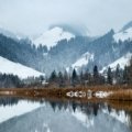 Scenic view of Swiss mountains and a crystal-clear lake, perfect for an unforgettable trip to the best places to travel in Switzerland.