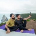 Two sisters, 'Wellness Wanderers', joyfully embodying healthy travel, fitness, and wellness, perhaps doing yoga or hiking in a beautiful destination, inspiring a balanced lifestyle on the go.