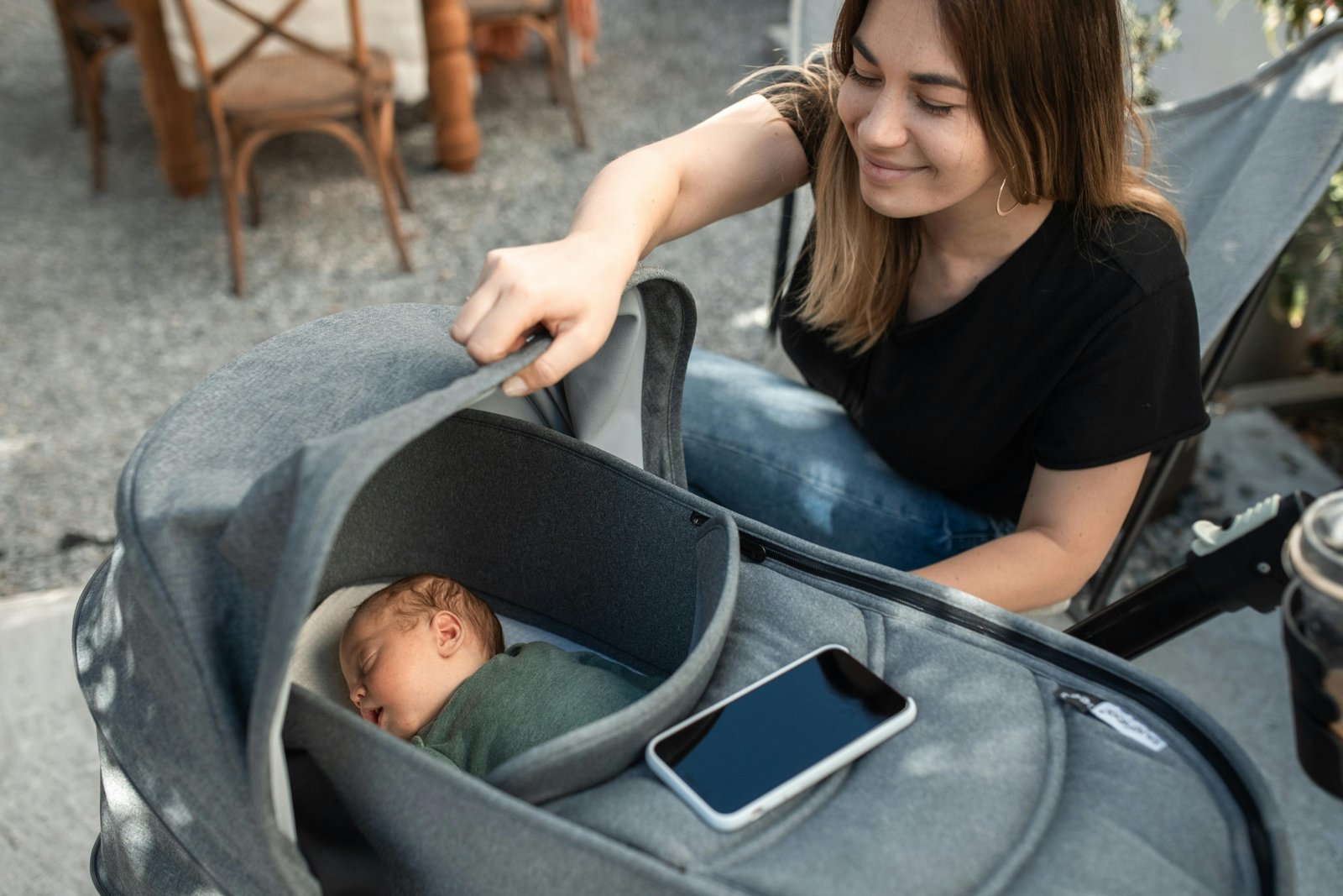 Active parents navigating a park with a modern baby travel system, featuring an infant car seat seamlessly attached to a stroller, showcasing convenience for safe and easy baby travel.