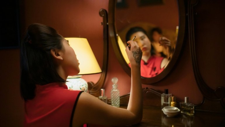 Portable LED travel makeup mirror for flawless application in a hotel room on vacation.