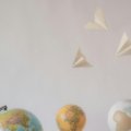 Minimalist travel tattoo ideas for wanderlust and adventure, featuring symbols like a compass, world map, and paper airplane design to inspire unique body art.
