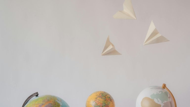 Minimalist travel tattoo ideas for wanderlust and adventure, featuring symbols like a compass, world map, and paper airplane design to inspire unique body art.