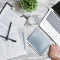 Aon travel claims guide: organized travel insurance documents, passport, and a digital claim form on a laptop, illustrating a smooth step-by-step filing process.