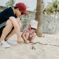 Professional travel nanny playing with happy children at a family-friendly resort, enabling parents to enjoy a relaxing and stress-free vacation.