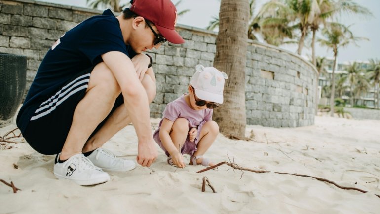 Professional travel nanny playing with happy children at a family-friendly resort, enabling parents to enjoy a relaxing and stress-free vacation.