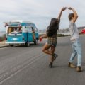 Happy traveler enjoying music on a scenic road trip, symbolizing the joy of travel songs and the freedom of adventure.