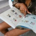 Portugal travel guide book open with hands and map for 2025 trip planning, illustrating the best travel guide books for an unforgettable Portuguese adventure.