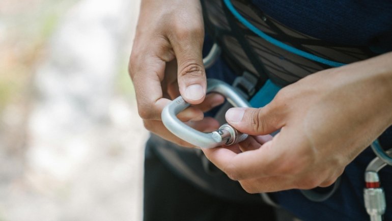 Compact travel toilet paper held by a traveler in a scenic outdoor environment, highlighting essential hygiene and preparedness for hiking, camping, and remote journeys.