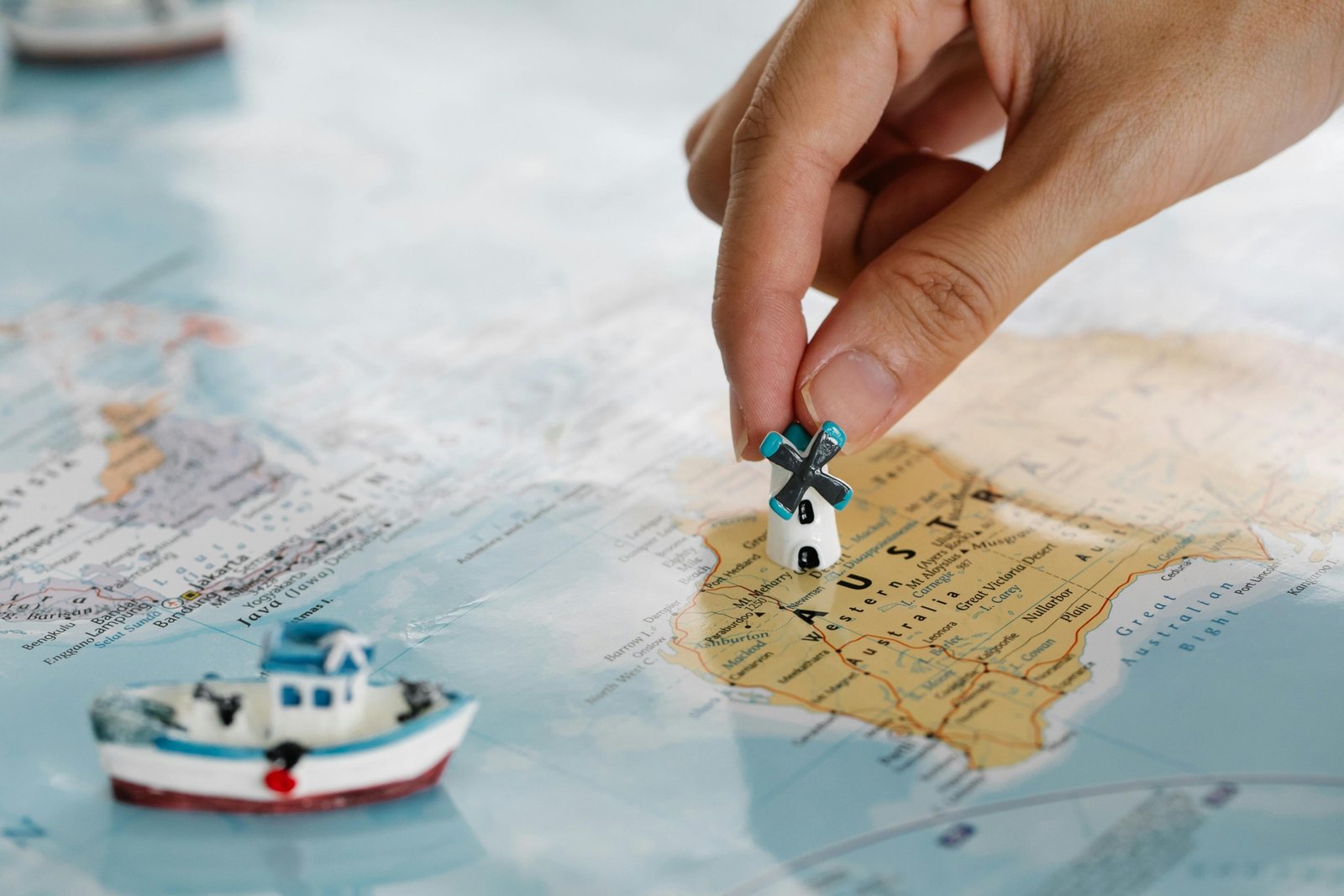Person planning an exciting international trip with a world map, passport, and travel essentials, highlighting expert inter travel preparation and global adventure.