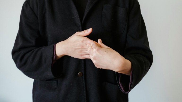 Hands demonstrating the ASL sign for 'travel' in American Sign Language, symbolizing visual communication for journeys and global exploration within the deaf community.
