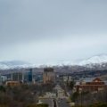 Diverse travel destinations across the USA for February, featuring a vibrant collage of warm sunny beaches, snowy mountain peaks, and bustling city skylines, highlighting unique experiences.