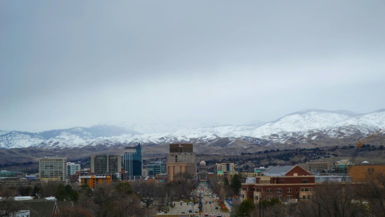 Diverse travel destinations across the USA for February, featuring a vibrant collage of warm sunny beaches, snowy mountain peaks, and bustling city skylines, highlighting unique experiences.