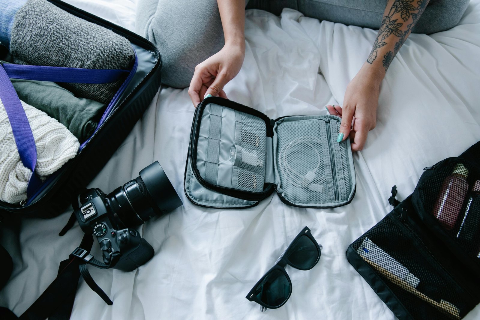 Traveler packing elegant travel-sized perfumes and solid fragrances into a clear carry-on bag, demonstrating smart techniques for airport security and spill prevention.
