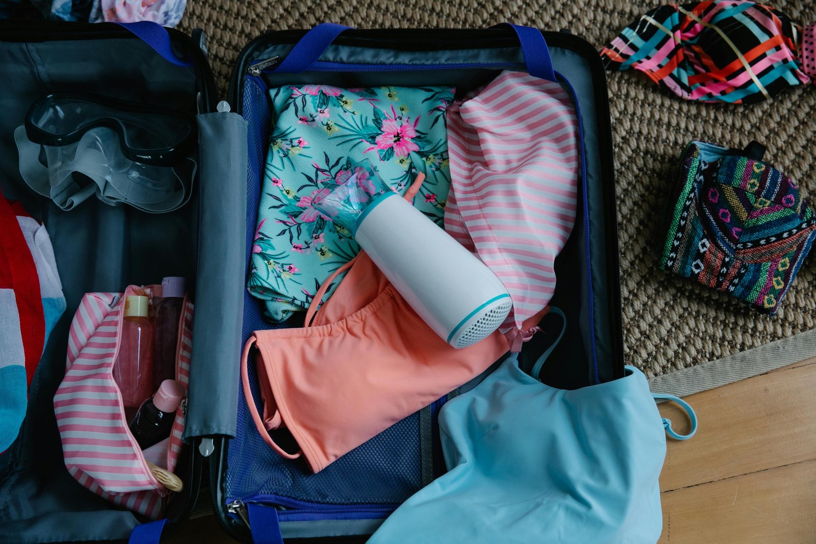 Colorful silicone travel bottles for shampoo and lotion, neatly organized in an open suitcase, highlighting their leak-proof design and stress-free packing for a trip.