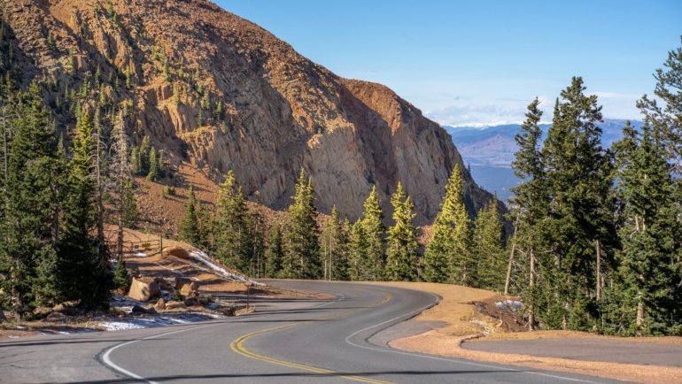 Scenic view of the majestic Rocky Mountains in Colorado, symbolizing diverse natural beauty and year-round adventures for travelers.