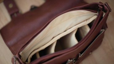 Custom personalized travel jewelry case, open and organized with rings, necklaces, and earrings in dedicated compartments, featuring a monogram, ready for elegant and stress-free travel.