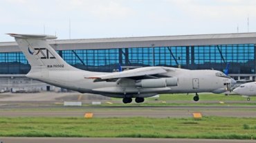 Military family with luggage at Travis AFB passenger terminal, ready for Space-Available (Space-A) travel, highlighting budget-friendly global travel for military personnel.