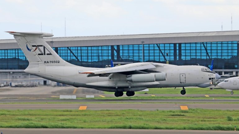 Military family with luggage at Travis AFB passenger terminal, ready for Space-Available (Space-A) travel, highlighting budget-friendly global travel for military personnel.