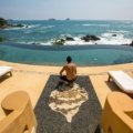 Luxurious Mexican resort infinity pool with an ocean view, emblematic of the exclusive benefits and unforgettable experiences offered by the Pueblo Bonito Travel Club membership.