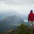 Adventurous traveler contemplating a vast, inspiring landscape, evoking wanderlust and the spirit of short travel quotes and personal journeys.