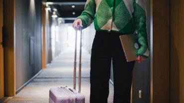 Professional travel agent booking and enjoying IHG luxury hotel personal trip with discounted rates.