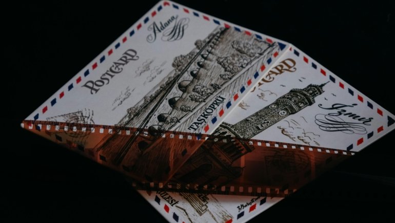 Multi-image travel postcard layout design being created on a digital screen, showcasing various travel photos and a cohesive theme for sharing vacation memories.