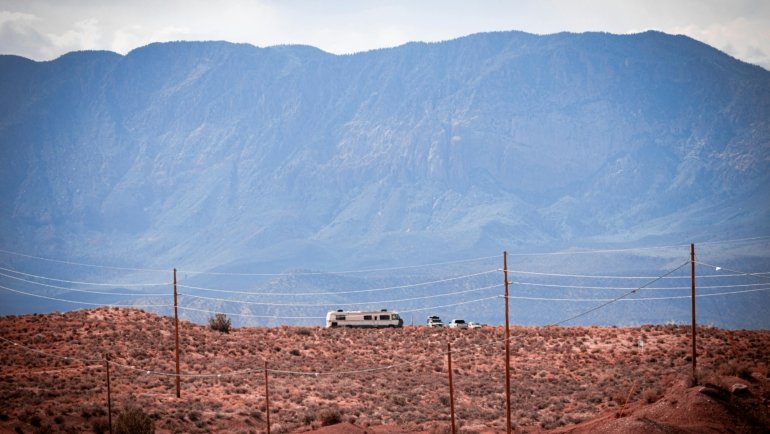 Ember travel trailer in a rugged wilderness setting, showcasing off-road capability and comfortable off-grid adventure.
