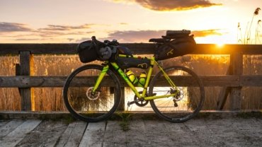 Premium EVOC bike travel bag at an airport, ensuring superior protection and peace of mind for cyclists traveling with their road, mountain, or triathlon bike.