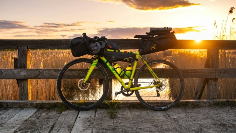 Premium EVOC bike travel bag at an airport, ensuring superior protection and peace of mind for cyclists traveling with their road, mountain, or triathlon bike.