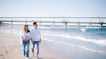 Happy pregnant couple enjoying a serene babymoon vacation, highlighting the peace of mind from comprehensive travel insurance for pregnant women and safe pregnancy travel.