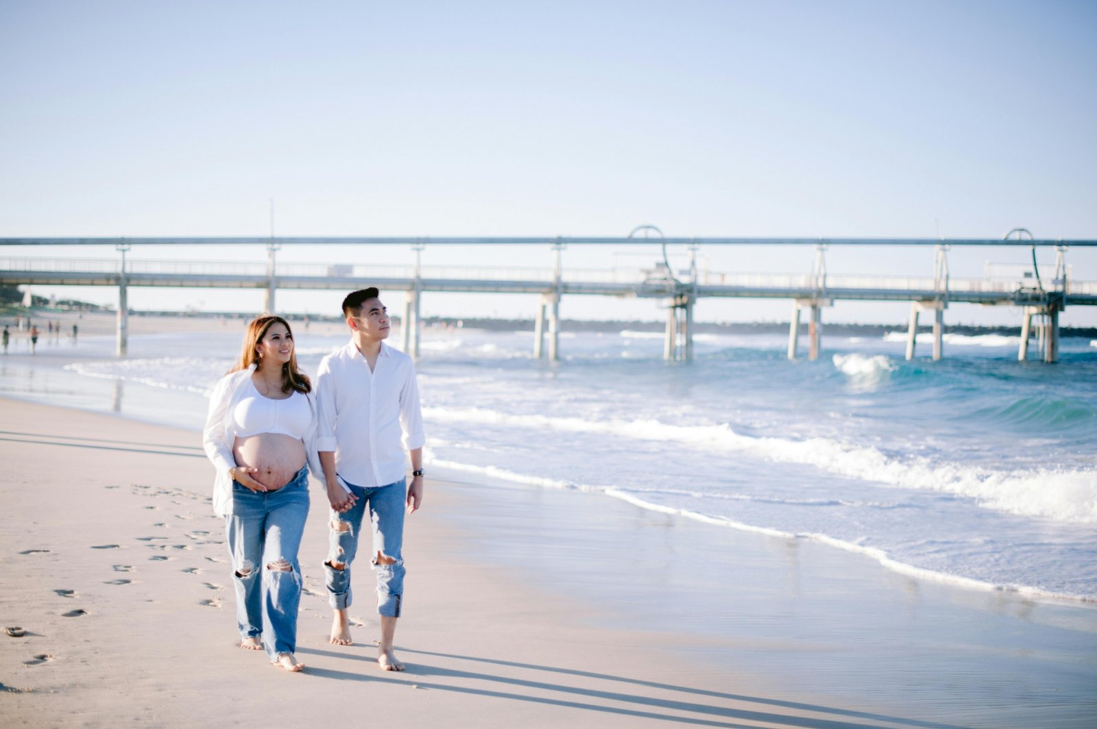 Happy pregnant couple enjoying a serene babymoon vacation, highlighting the peace of mind from comprehensive travel insurance for pregnant women and safe pregnancy travel.