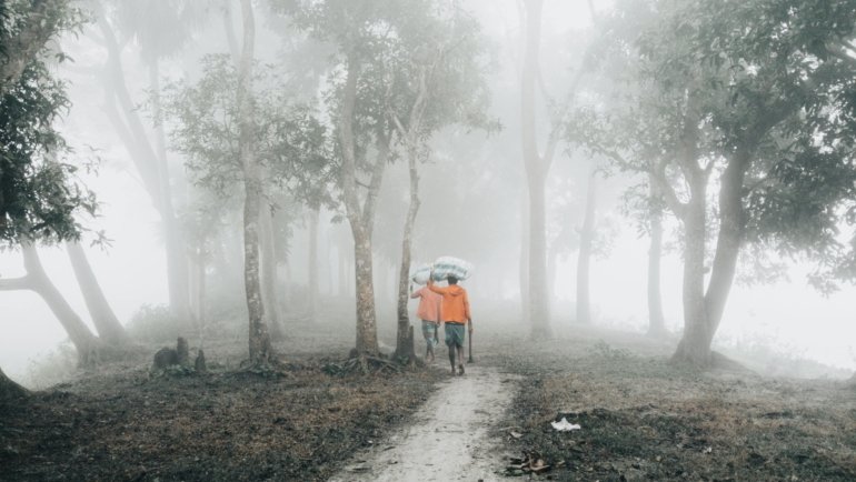 Traveler applying portable travel size mosquito repellent for essential insect protection during a tropical trip, ensuring comfort and safety.