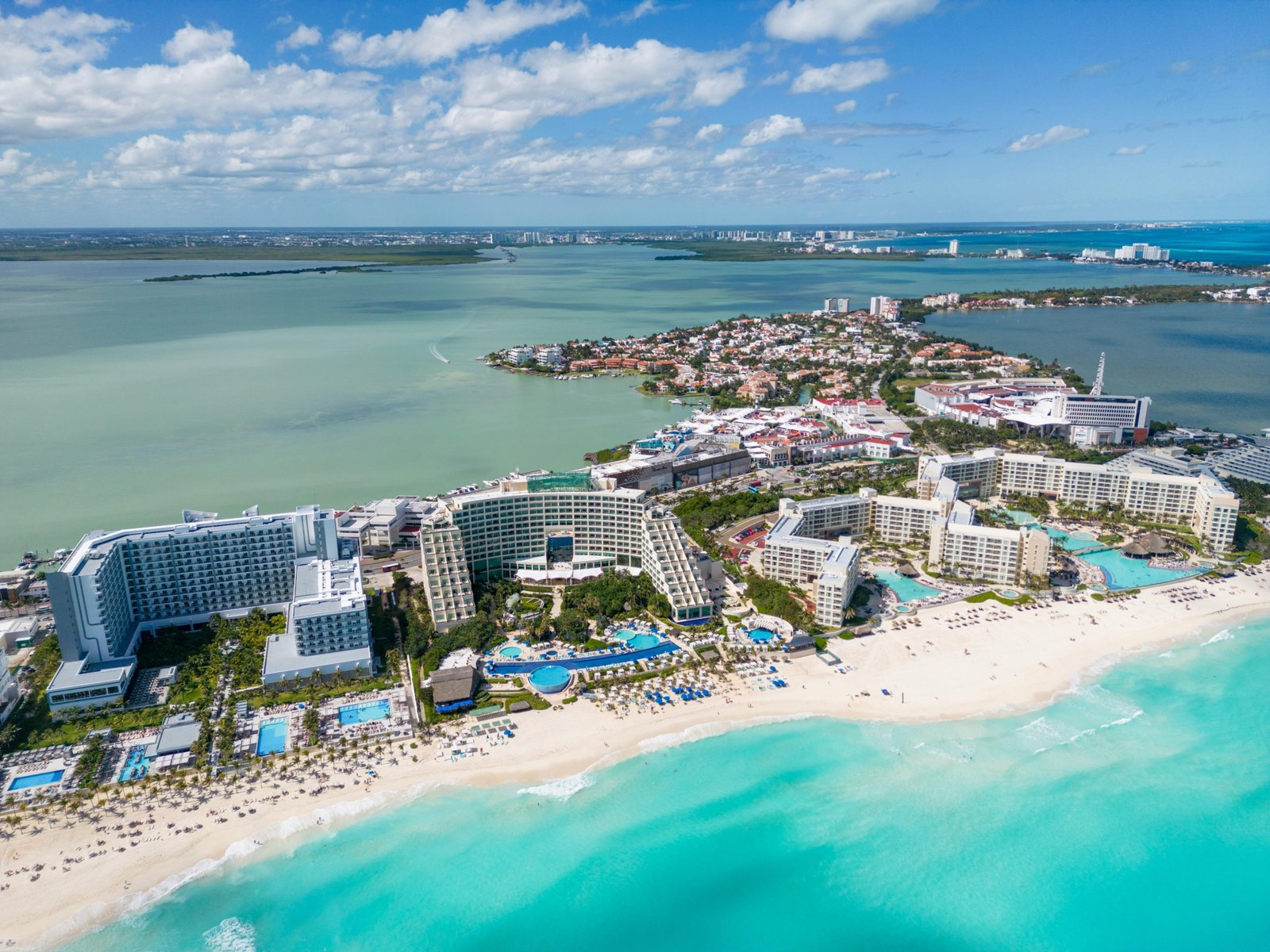 Luxurious all-inclusive tropical resort with pristine white-sand beach and turquoise ocean, illustrating the exceptional value and stress-free experience of Costco Travel vacation packages.