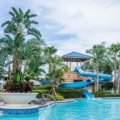 Valencia Travel Village RV Resort in Southern California, showcasing modern RVs, a heated swimming pool, and families enjoying a sunny vacation in Castaic near Six Flags Magic Mountain.