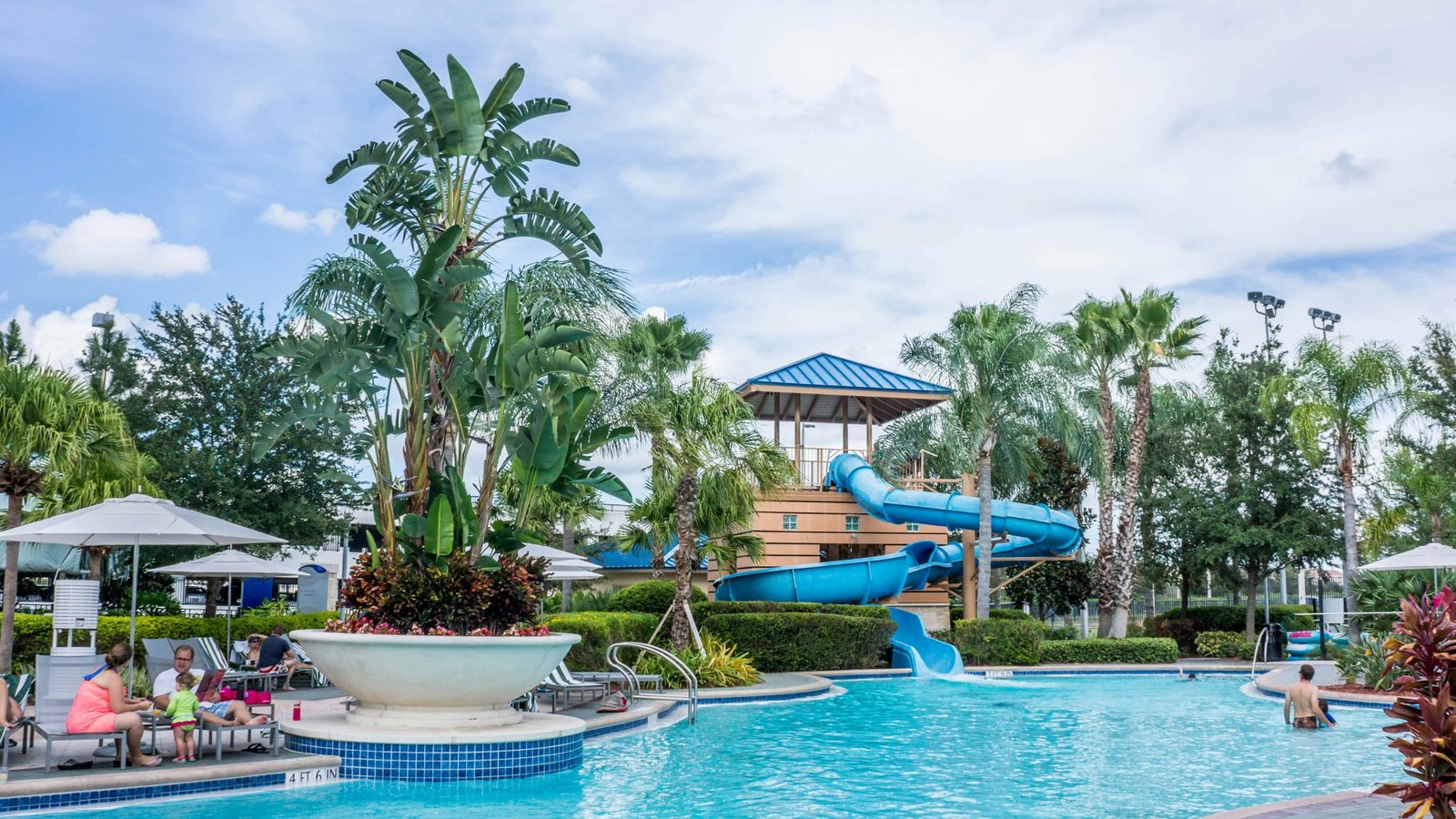 Valencia Travel Village RV Resort in Southern California, showcasing modern RVs, a heated swimming pool, and families enjoying a sunny vacation in Castaic near Six Flags Magic Mountain.