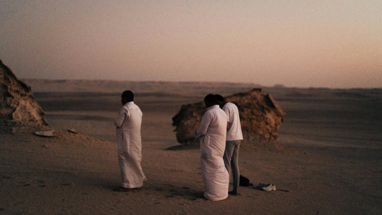 A Muslim traveler offering the Traveling Dua (Dua e Safar) for protection and peace before embarking on their journey, symbolizing spiritual reliance on Allah.