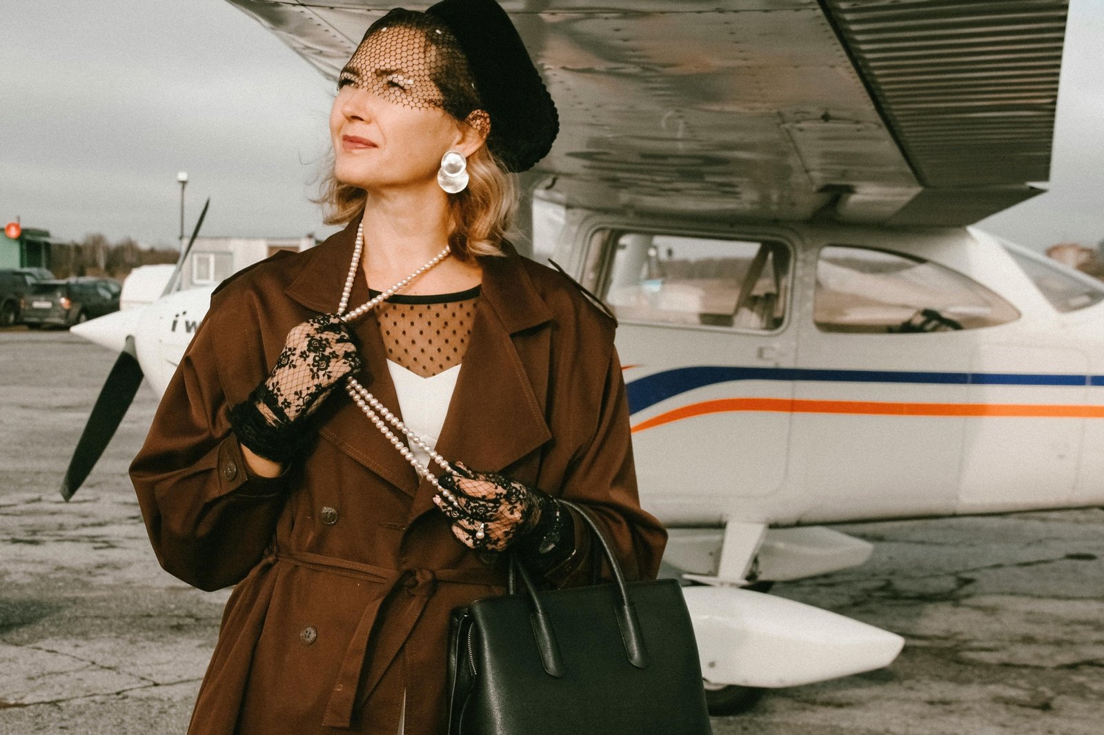 Stylish traveler with a luxury Dior-style travel bag at a modern airport, representing sophisticated journeys and premium luggage.