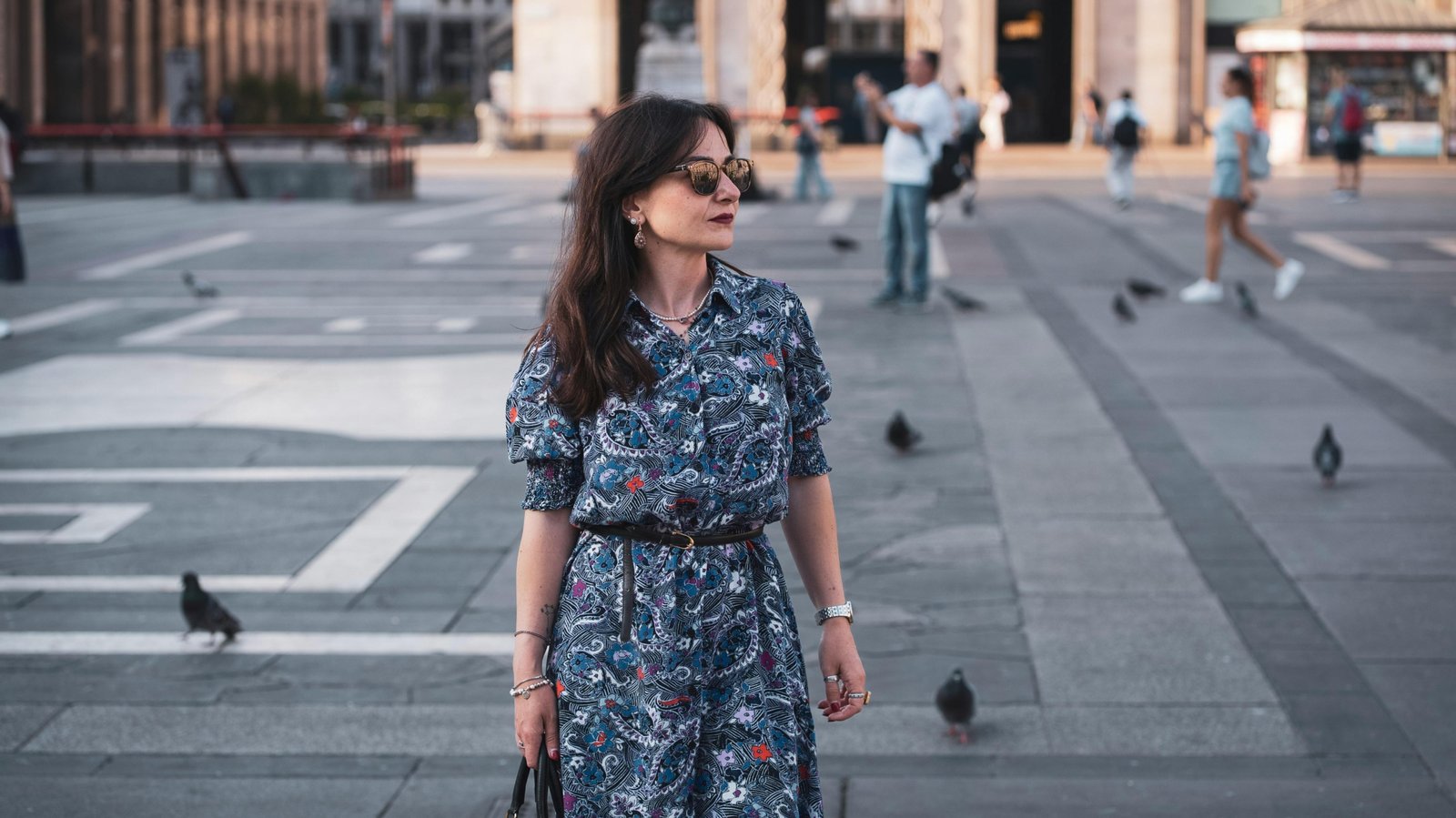 Stylish woman with a secure anti-theft travel purse exploring a European city street, highlighting comfort and peace of mind for safe travel.