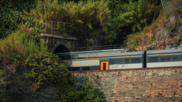 Traveler enjoying scenic Italian train journey, embodying smart Eurail Pass Italy travel advice for 2025 and flexible exploration.